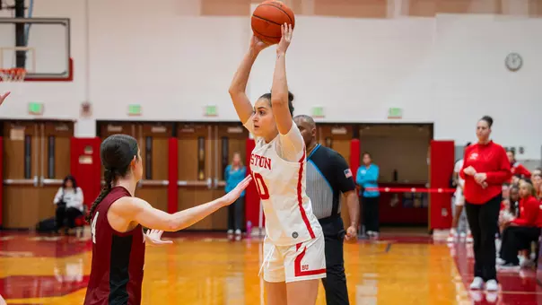 Photo of BU women's basketball sophomore Rose Azmoudeh passing the ball at Case Gym.
