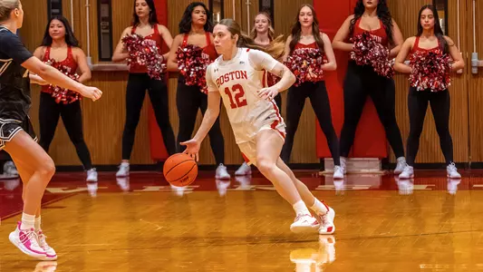 Photo of BU women's basketball junior Bella McLaughlin dribbling the ball at Case Gym.