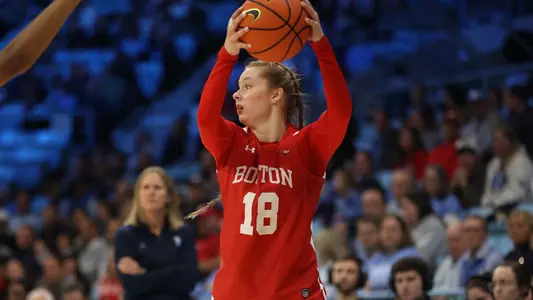 Photo of BU women's basketball sophomore Hildur Gunnsteinsdóttir holding the ball over her head.