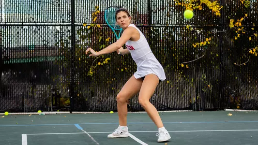 Ellie Gyuro playing tennis and making a forehand shot