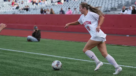 Photo of BU women's soccer senior Ava Maguire dribbling the ball at Nickerson Field.
