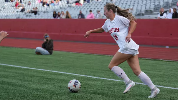 Photo of BU women's soccer senior Ava Maguire dribbling the ball at Nickerson Field.