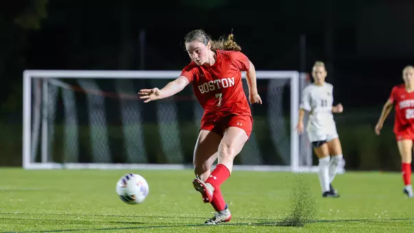 Photo of BU women's soccer sophomore Georgia Prouty shooting a ball at Nickerson Field.