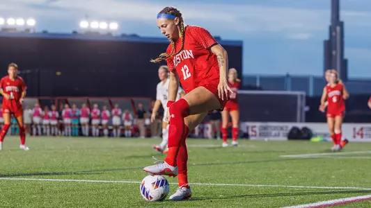 Photo of BU women's soccer junior Jaiden Schultz dribbling the ball at Nickerson Field.