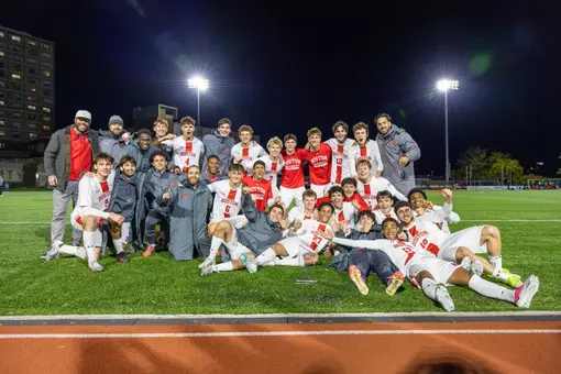 Men's soccer poses with Patriot League trophy