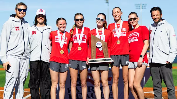BU women's cross country athletes and coaches pose with Patriot League runner-up trophy