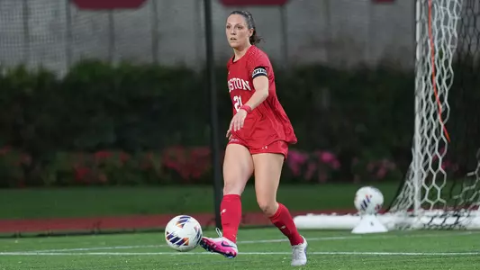 Photo of BU women's soccer senior Helene Tyburczy kicking the ball at Nickerson Field.