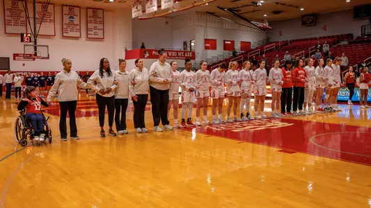 Photo of the BU Women's Basketball team lining up for the national anthem.