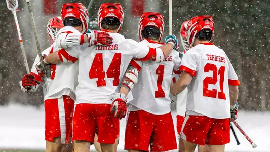 Men's lacrosse players celebrate a goal