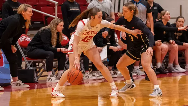 Photo of BU women's basketball junior Bella McLaughlin dribbling the ball vs. Army West Point.