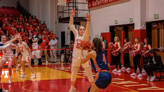 Photo of BU women's basketball senior Anastasiia Semenova attempting to block a Bucknell shot at Case Gym.