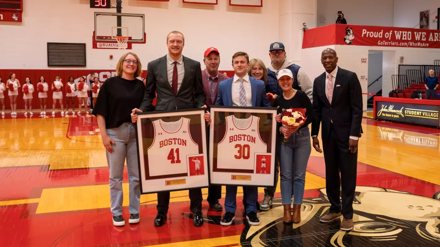 Otto Landrum and Ben Roy gather with head coach Joe Jones and family for a pregame Senior Day photo