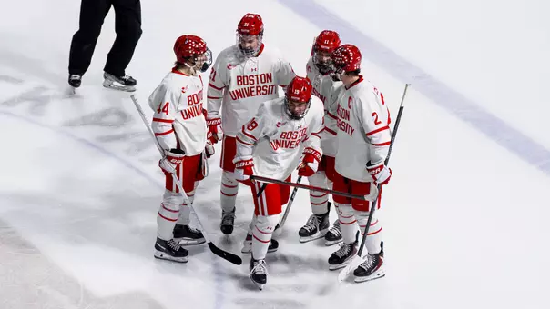 Men's hockey players celebrate a goal against UNH