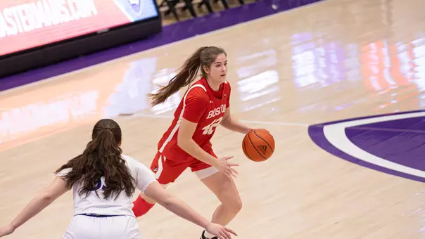 Photo of BU women's basketball sophomore Allison Schwertner dribbling the ball at Holy Cross.