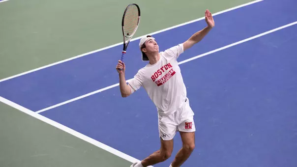 Men's tennis serving the ball at Harvard