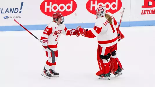 Lexie Bertelsen and Michelle Pasiechnyk fist bump on the ice