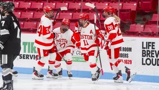 Women's ice hockey celebrates goal at walter brown arena