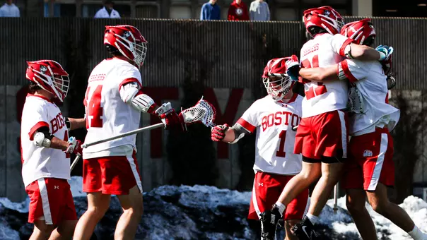 BU men's lacrosse players celebrate a goal against Navy