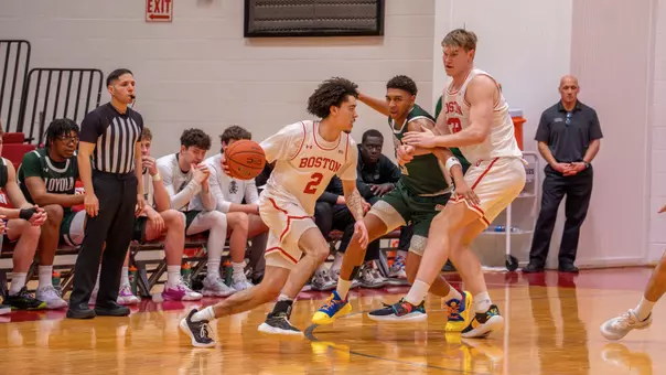 Chance Gladden dribbles the ball toward the hoop with Quinn Nielsen helping set a screen