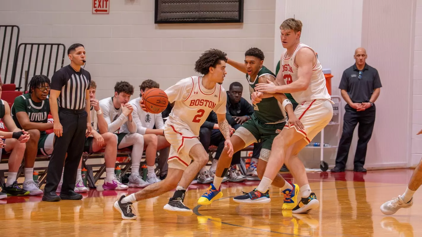 Chance Gladden dribbles the ball toward the hoop with Quinn Nielsen helping set a screen