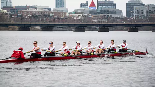 Photo of the BU Lightweight Rowing Varsity 8 racing on the Charles River.