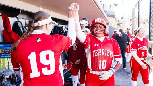 Kyomi Apalit high fives Kieren McHugh after scoring a run