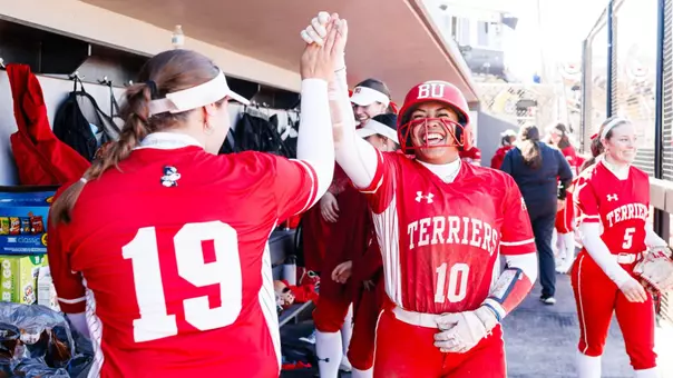 Kyomi Apalit high fives Kieren McHugh after scoring a run