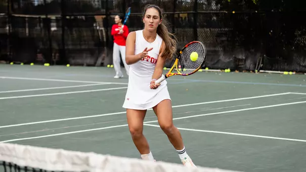 Gabriella Mikaul hits a volley at the net