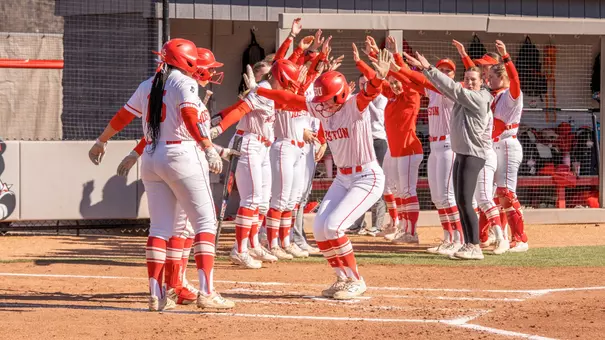 The Terrier celebrate a home run hit against UConn by making a tunnel leading into the dugout