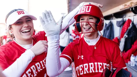 Sophie Naivar high fives a teammate after scoring a run