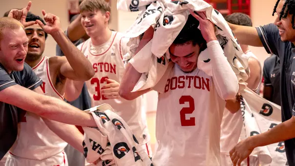 Chance Gladden celebrates with teammates after hitting game-winning shot against American in PL quarterfinal