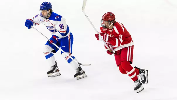 Tynan Lawrence skating next to a UMass Lowell player