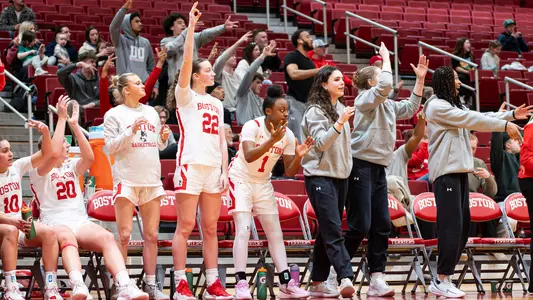 Photo of the BU Women's Basketball bench celebrating at Case Gym.