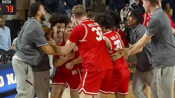 Team celebrates around Chance Gladden after game-winning shot at Navy in Patriot League semifinal