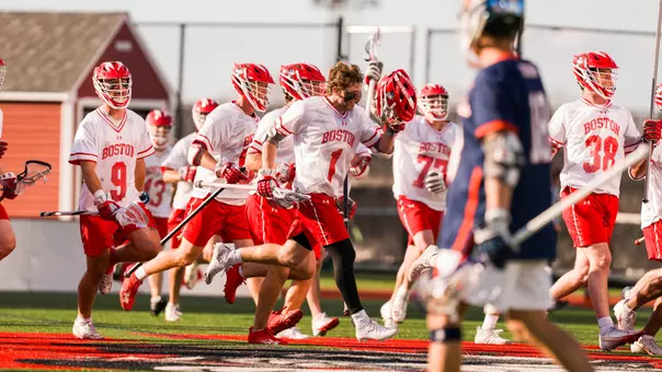 Timothy Shannehan celebrates with his teammates as they run to the fans after an overtime win over Bucknell