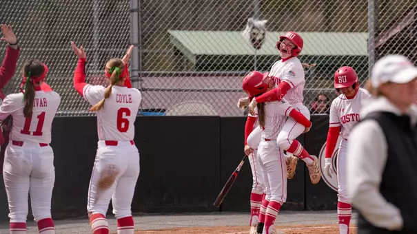 Kylie Doherty is picked up by a teammate after hitting a homer and touching home plate