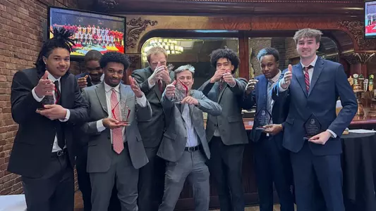The BU men's basketball award winners pose for a photo at the end of the team's annual banquet.