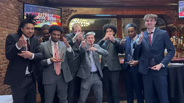 The BU men's basketball award winners pose for a photo at the end of the team's annual banquet.