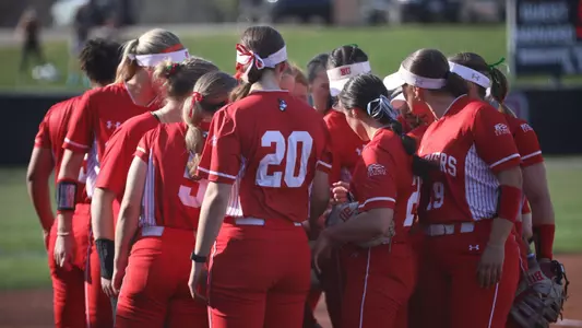 BU softball team huddles together at Harvard.