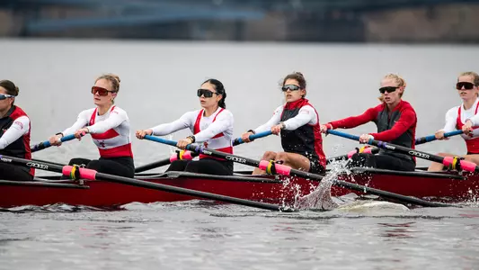 Photo of the BU Lightweight Rowing team racing on the Charles River.