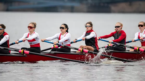 Photo of the BU Lightweight Rowing team racing on the Charles River.