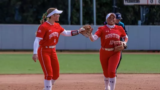 Kyomi Apalit and Megan Coyle tap gloves after an out