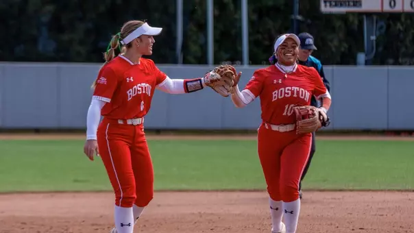 Kyomi Apalit and Megan Coyle tap gloves after an out