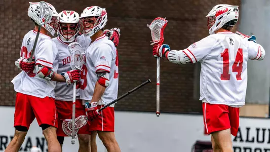 Men's lacrosse players celebrating a goal
