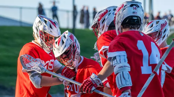 BU men's lacrosse players celebrate Matt Freeman's goal at Holy Cross