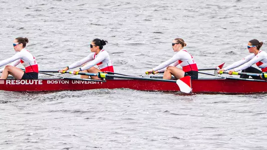 Photo of the BU Lightweight Rowing Fours racing on the Charles River.