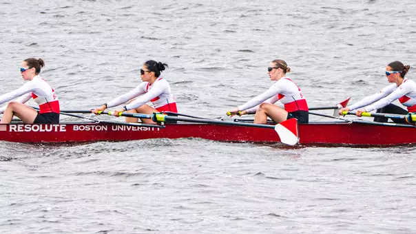 Photo of the BU Lightweight Rowing Fours racing on the Charles River.