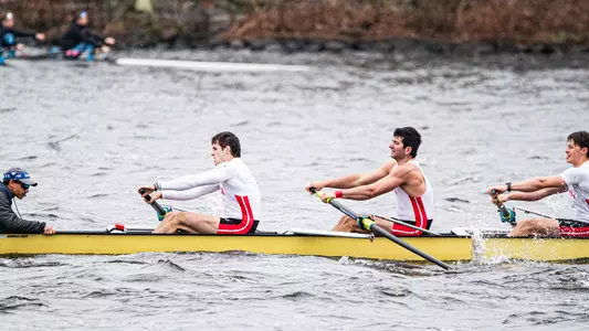 Photo of the BU Men's Rowing Fifth Varsity 8 racing on the Charles River.