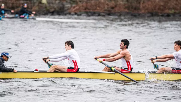 Photo of the BU Men's Rowing Fifth Varsity 8 racing on the Charles River.