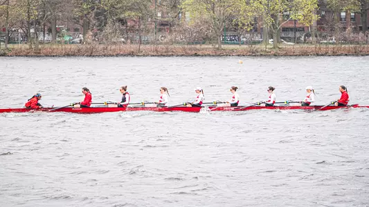 Photo of the BU Lightweight Rowing 8 racing on the Charles River.